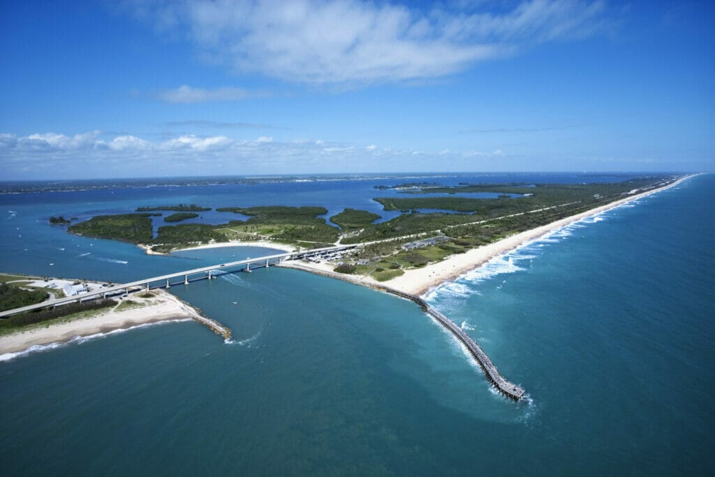 Aerial view of Indian River Lagoon Scenic Highway on Melbourne Beach, Florida with inlet and pier.